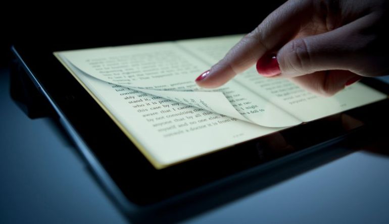 A digital book is displayed on an Apple Inc. iPad for a photograph in New York, U.S., on Wednesday, April 11, 2012. Apple Inc. and two publishers, Macmillan and Penguin, were accused by the U.S. Justice Department of conspiring to fix prices of digital books to undermine Amazon.com Inc.'s dominance of the industry. Photographer: Scott Eells/Bloomberg via Getty Images